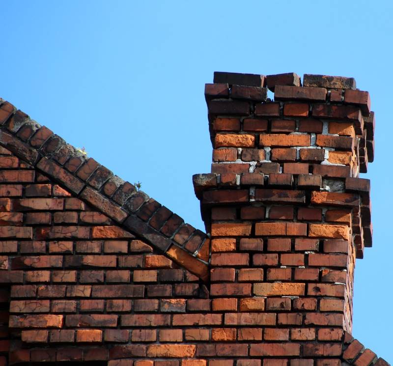 Signs Your Stoneham Home Needs a Chimney Inspection Damaged chimney on an Stoneham home showing cracks and missing mortar